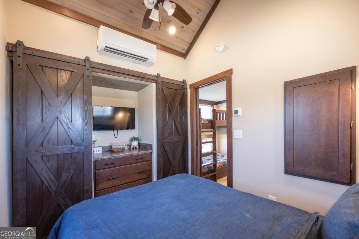 192 Mountain Road Morganton, GA 30560 - Photo 16 of 42 a bedroom with a bed and a flat screen tv