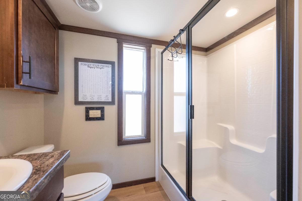 192 Mountain Road Morganton, GA 30560 - Photo 17 of 42 a bathroom with a toilet a sink and shower