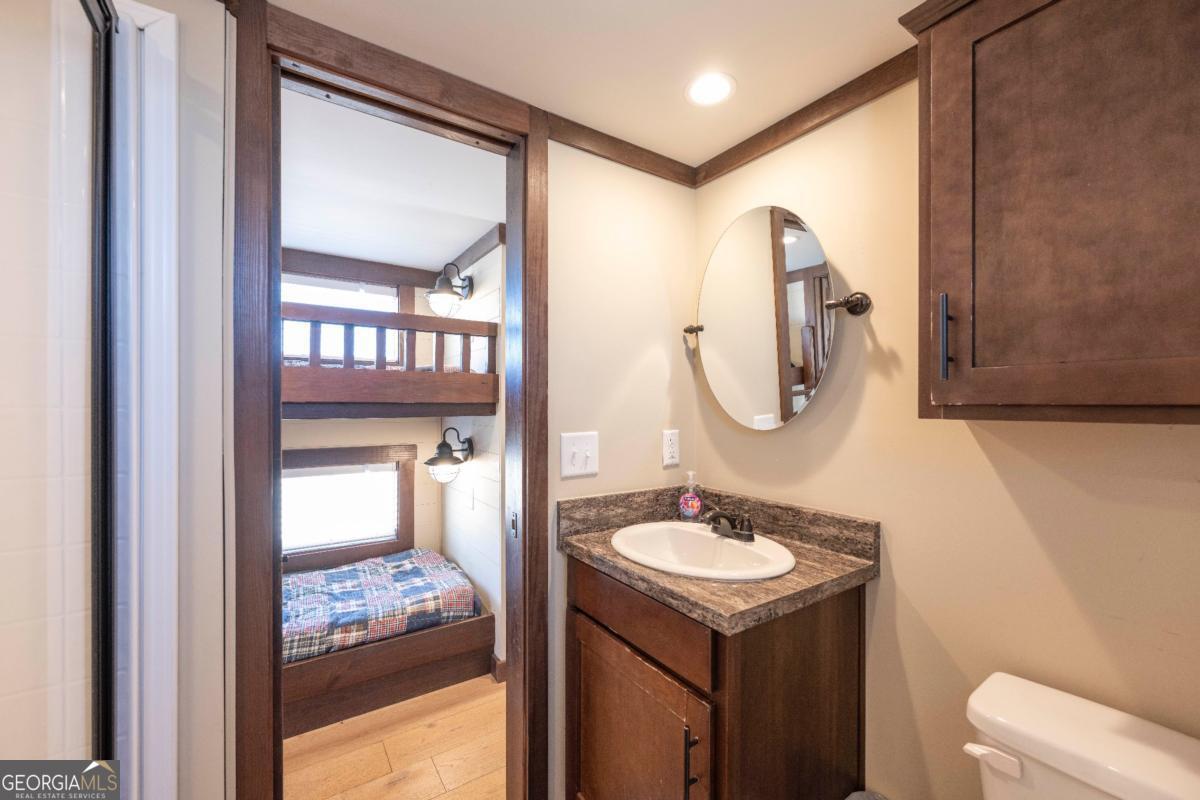192 Mountain Road Morganton, GA 30560 - Photo 18 of 42 a bathroom with a sink vanity and a mirror