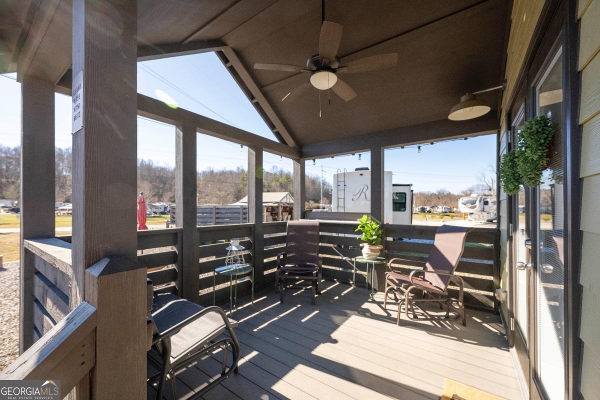 192 Mountain Road Morganton, GA 30560 - Photo 4 of 42 a view of a balcony with couch and wooden floor
