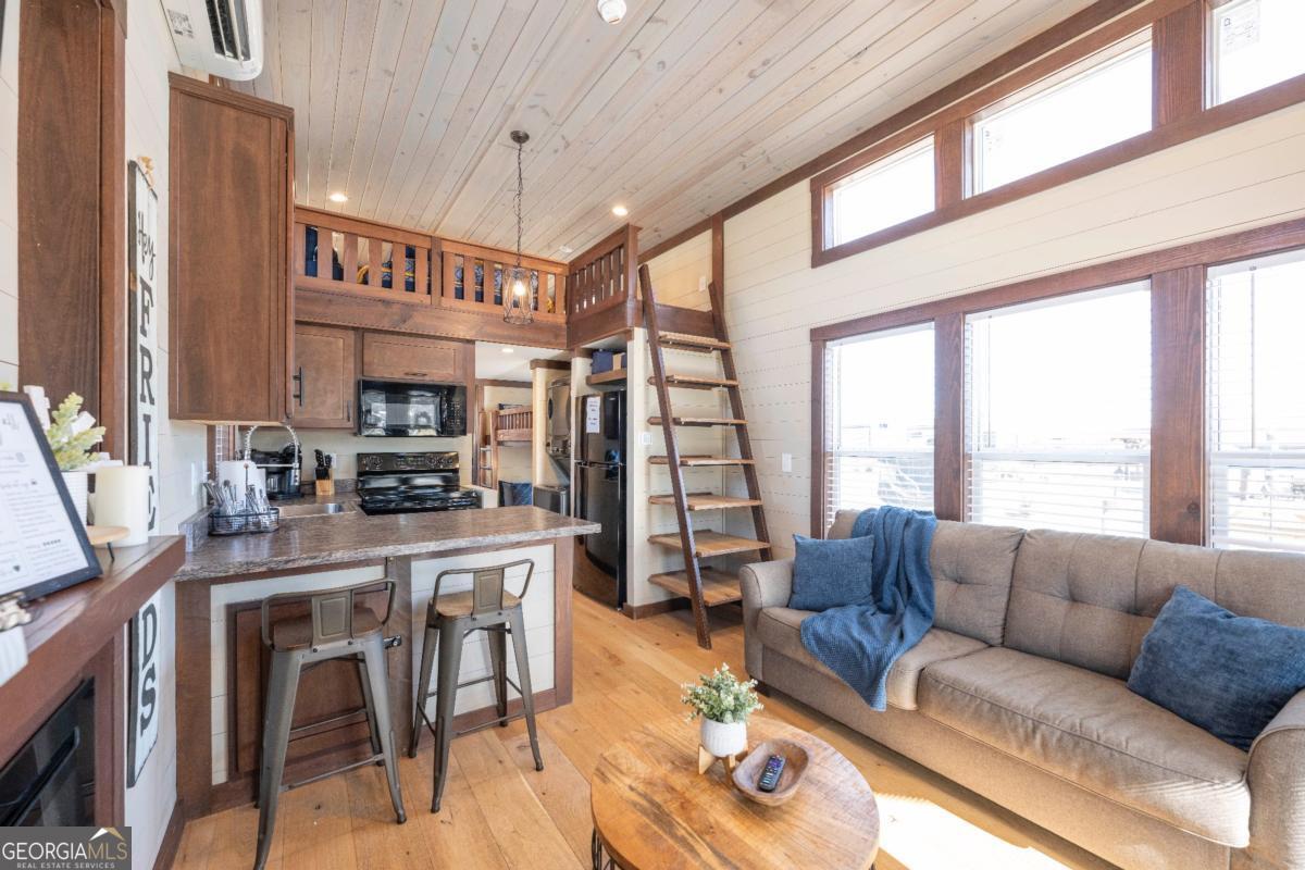 192 Mountain Road Morganton, GA 30560 - Photo 7 of 42 a living room with furniture a flat screen tv and a large window