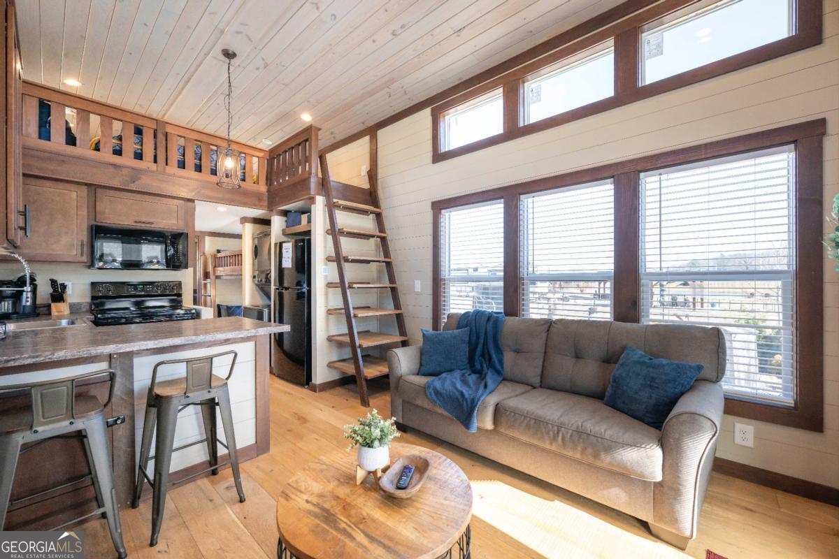 192 Mountain Road Morganton, GA 30560 - Photo 8 of 42 a living room with furniture a fireplace and a large window