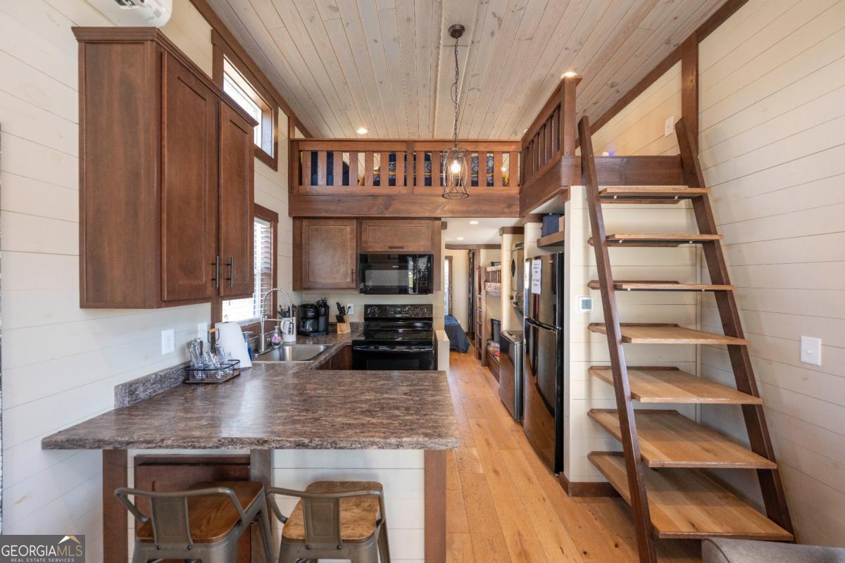 192 Mountain Road Morganton, GA 30560 - Photo 9 of 42 a kitchen with stainless steel appliances granite countertop a sink and cabinets