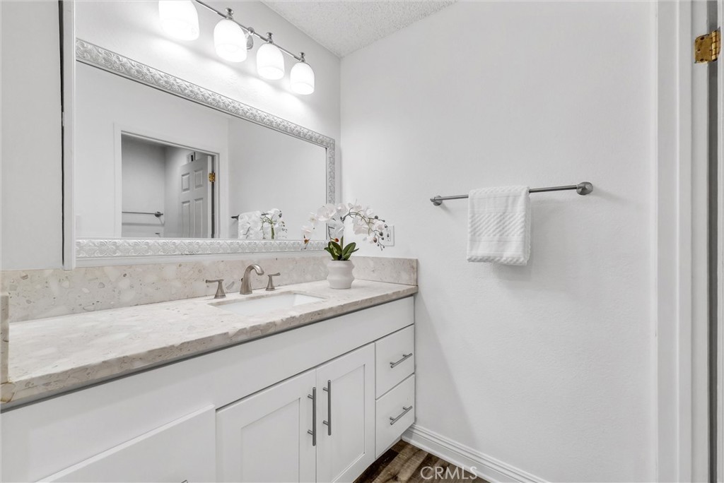 1030 West MacArthur Boulevard, Unit 5 Santa Ana, CA 92707 - Photo 19 of 26 a bathroom with a sink and a mirror