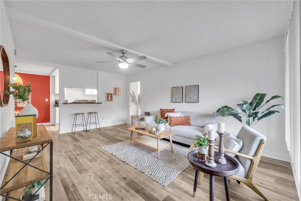 1030 West MacArthur Boulevard, Unit 5 Santa Ana, CA 92707 - Photo 2 of 26 a living room with furniture and a wooden floor