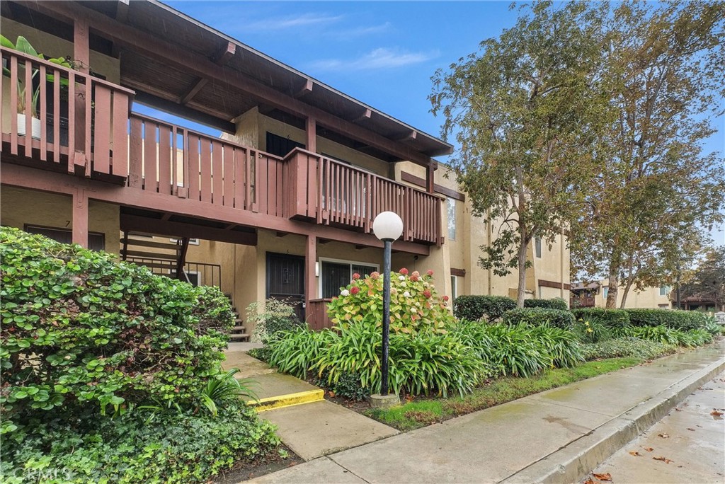 1030 West MacArthur Boulevard, Unit 5 Santa Ana, CA 92707 - Photo 22 of 26 a view of a house with potted plants and a large tree
