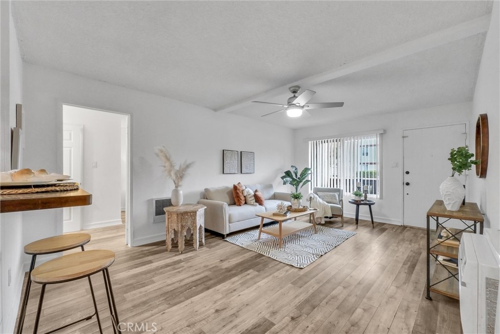 1030 West MacArthur Boulevard, Unit 5 Santa Ana, CA 92707 - Photo 3 of 26 a living room with furniture and a wooden floor