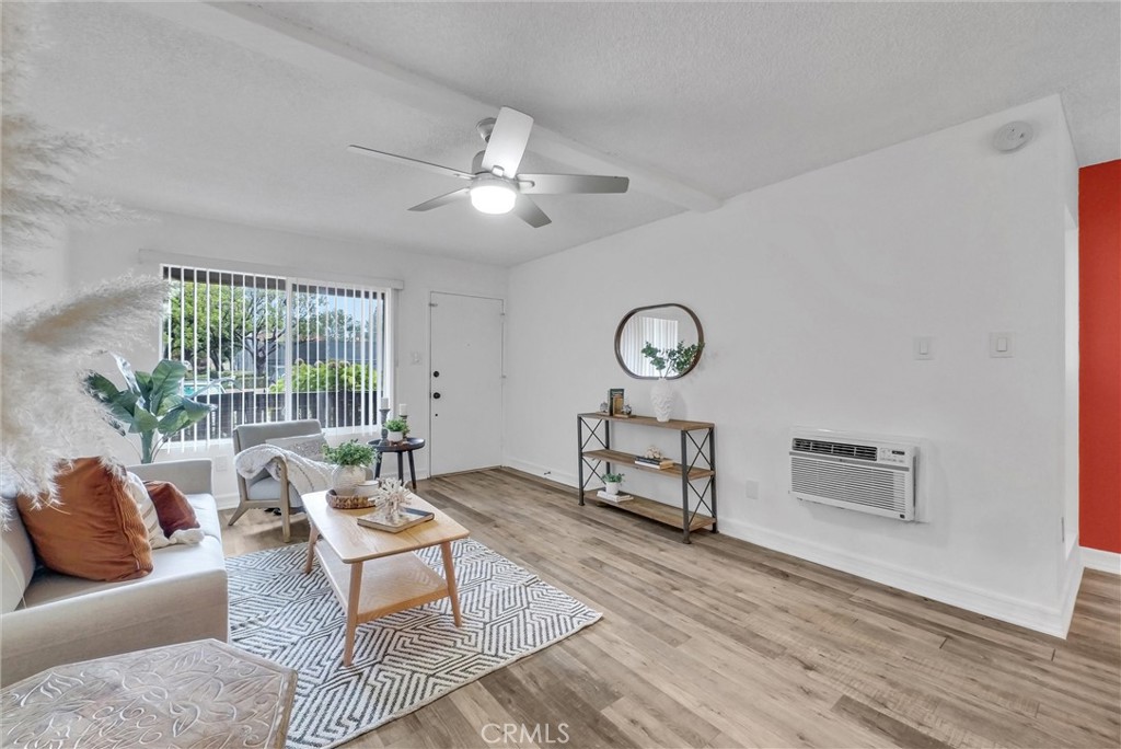 1030 West MacArthur Boulevard, Unit 5 Santa Ana, CA 92707 - Photo 4 of 26 a living room with furniture and a large window
