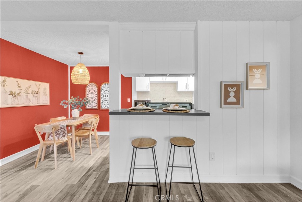 1030 West MacArthur Boulevard, Unit 5 Santa Ana, CA 92707 - Photo 5 of 26 a dining room with furniture and wooden floor