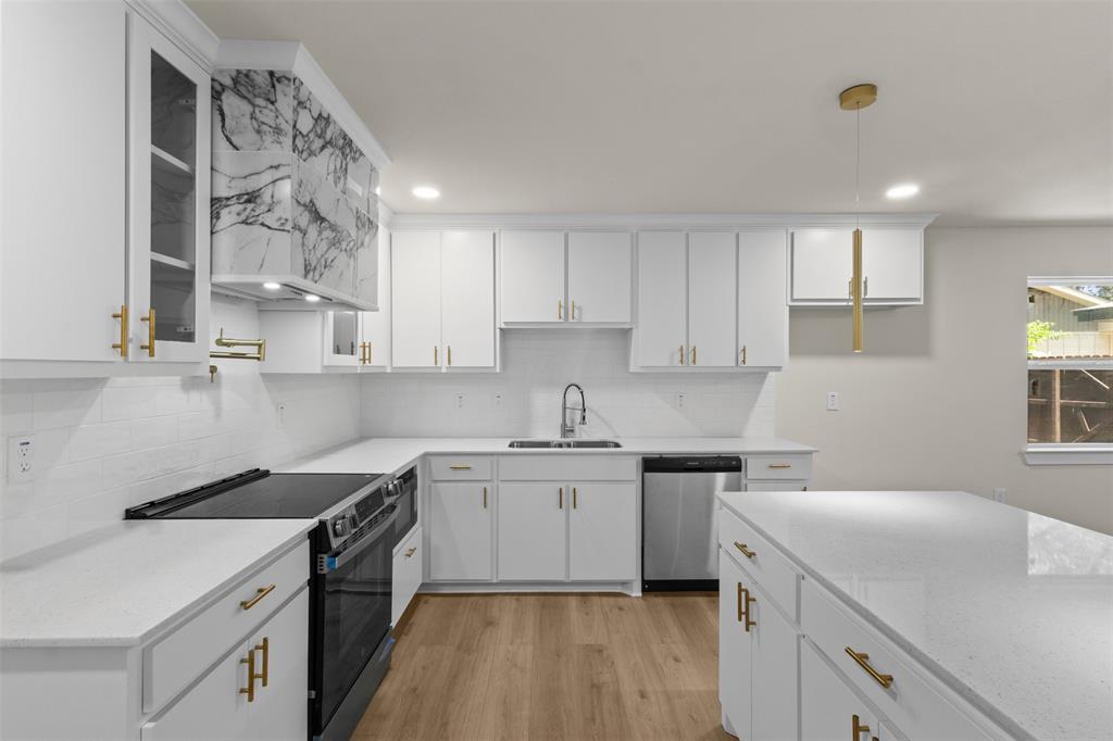 907 Pinson Road Forney, TX 75126 - Photo 11 of 35 Contemporary kitchen featuring white cabinetry, quartz countertops, and gold-tone hardware