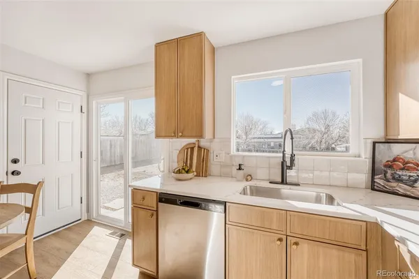 a kitchen with stainless steel appliances granite countertop a sink and a window