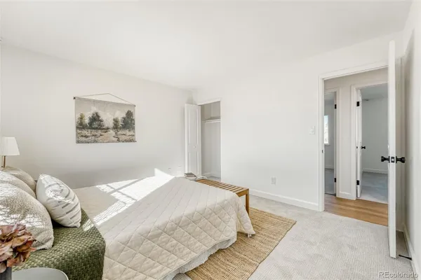a bedroom with a large bed and a couch