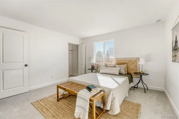 a bed room with a bed and a chair