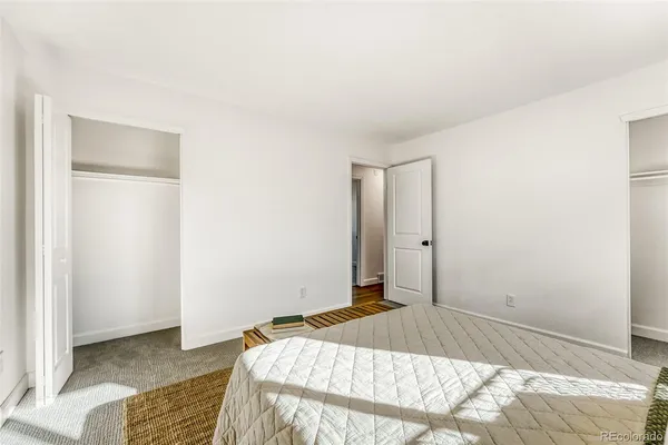 a bedroom with a bed and a mirror