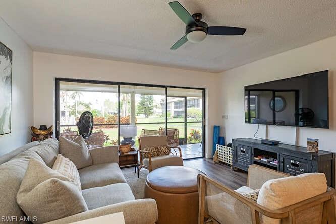 252 Pebble Beach Circle, Unit C103 Naples, FL 34113 - Photo 1 of 13 a living room with furniture and a flat screen tv