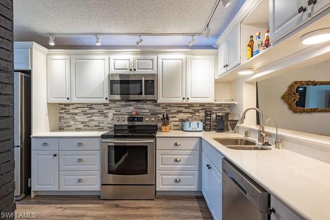 252 Pebble Beach Circle, Unit C103 Naples, FL 34113 - Photo 3 of 13 a kitchen with stainless steel appliances granite countertop a stove and a sink