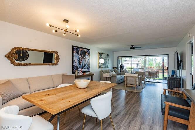 252 Pebble Beach Circle, Unit C103 Naples, FL 34113 - Photo 4 of 13 a living room with furniture and wooden floor