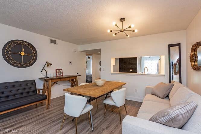 252 Pebble Beach Circle, Unit C103 Naples, FL 34113 - Photo 5 of 13 a living room with furniture and a flat screen tv