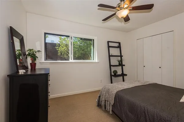a bedroom with a bed and a potted plant
