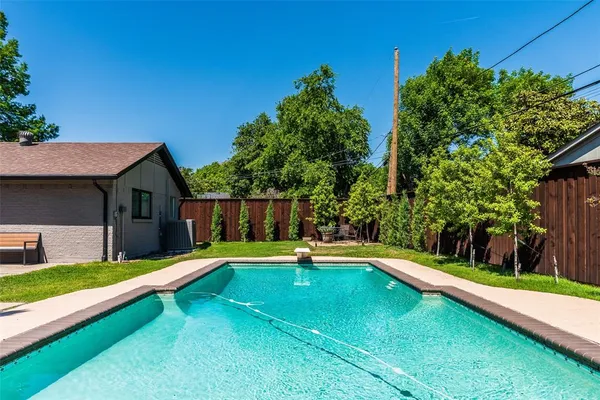 a view of an house with swimming pool yard and patio