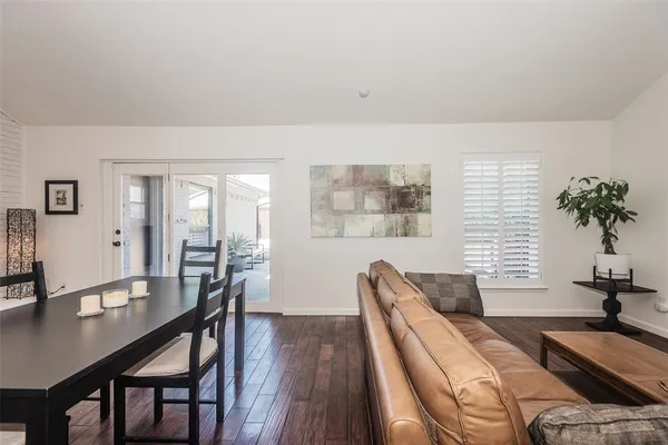 a view of a livingroom with furniture window and wooden floor