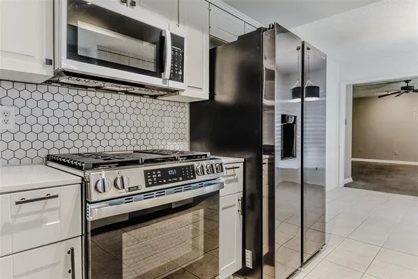 a stove top oven sitting inside of a kitchen