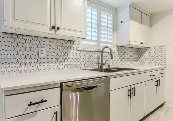 a kitchen with a sink and cabinets