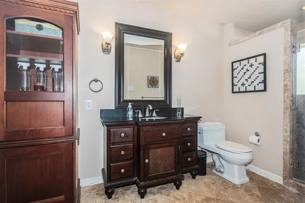 a bathroom with a toilet a sink and mirror
