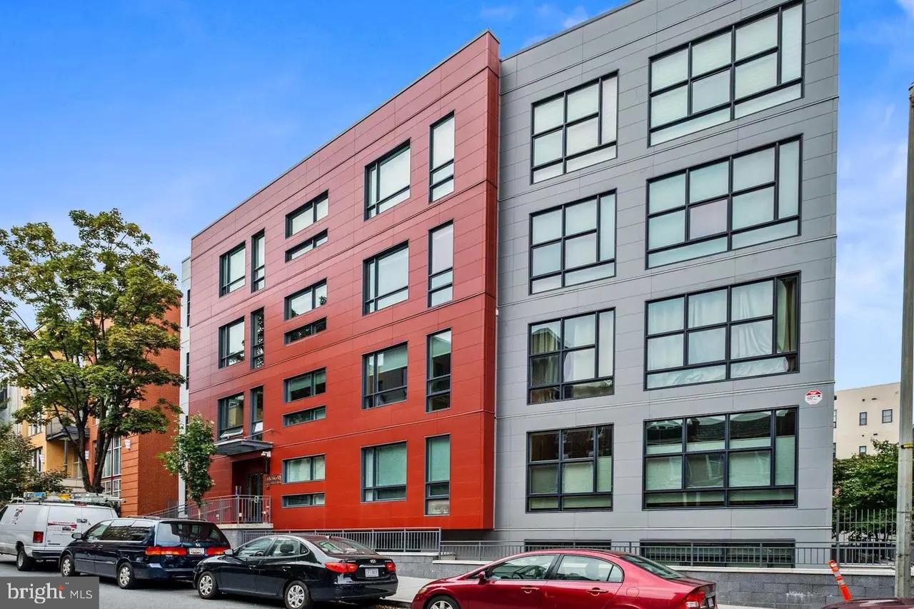 2337 Champlain Street Northwest, Unit 104 Washington, DC 20009 - Photo 1 of 29 a front view of a building with lot of windows