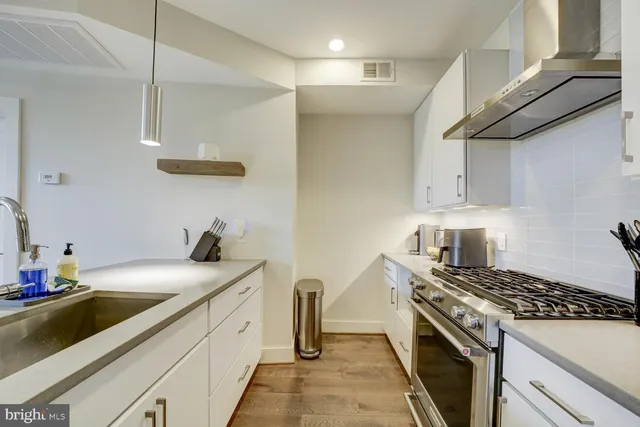 a kitchen with stainless steel appliances granite countertop a sink and cabinets