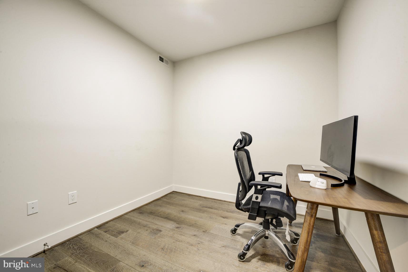 2337 Champlain Street Northwest, Unit 104 Washington, DC 20009 - Photo 14 of 29 a view of workspace with wooden floor windows