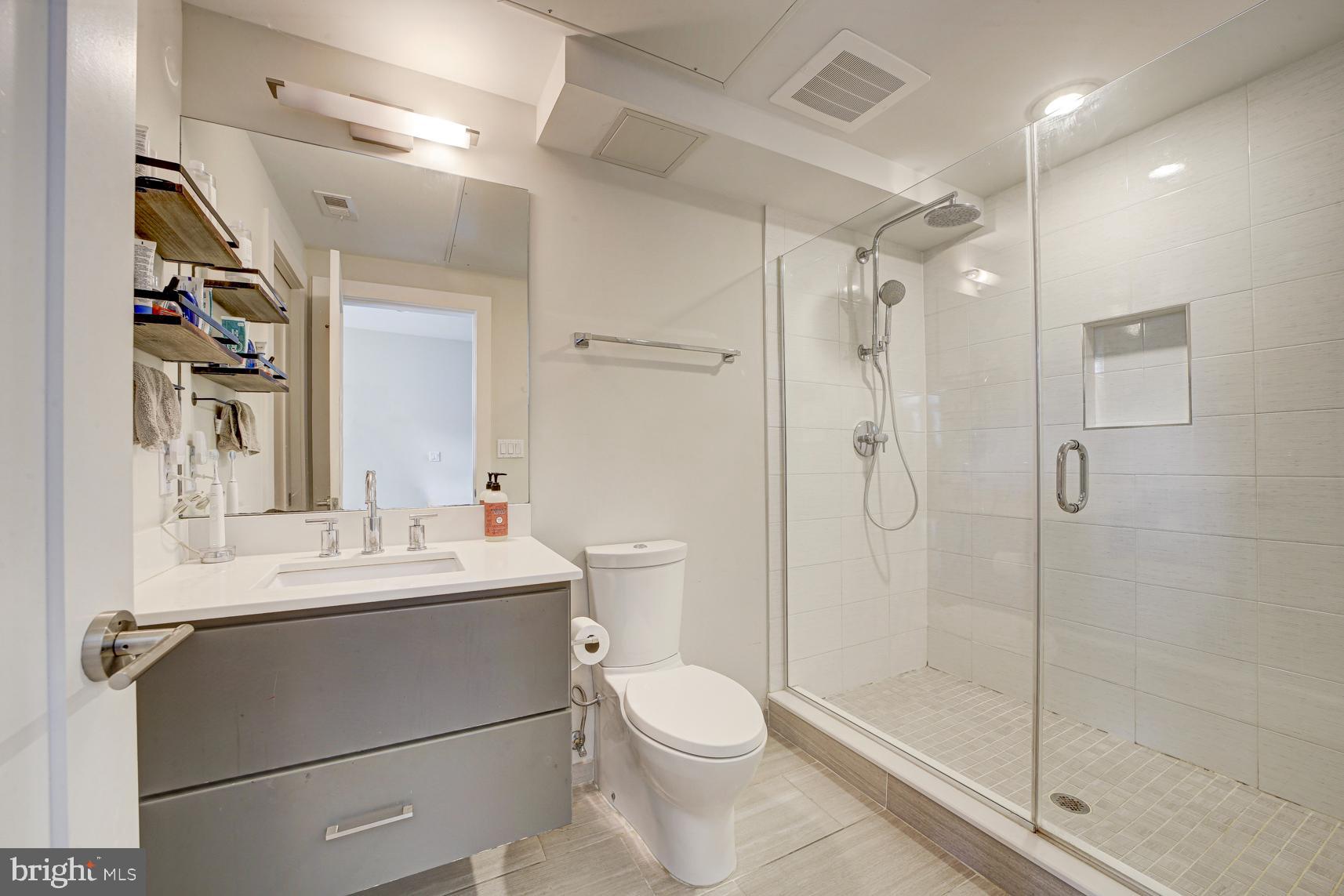2337 Champlain Street Northwest, Unit 104 Washington, DC 20009 - Photo 15 of 29 a bathroom with a sink a toilet and shower
