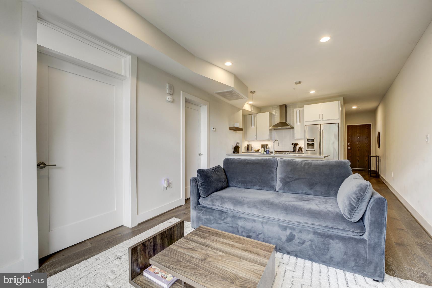 2337 Champlain Street Northwest, Unit 104 Washington, DC 20009 - Photo 8 of 29 a living room with a couch and a refrigerator