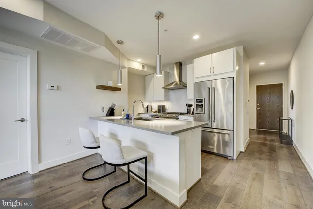 a kitchen with refrigerator cabinets and wooden floor