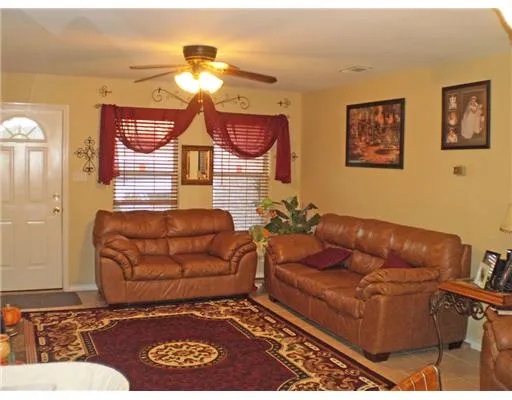 a living room with furniture a window and a chandelier