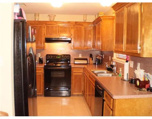 a kitchen with a sink a stove and a microwave