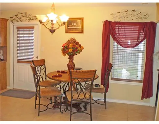 a view of a dining room with furniture and window