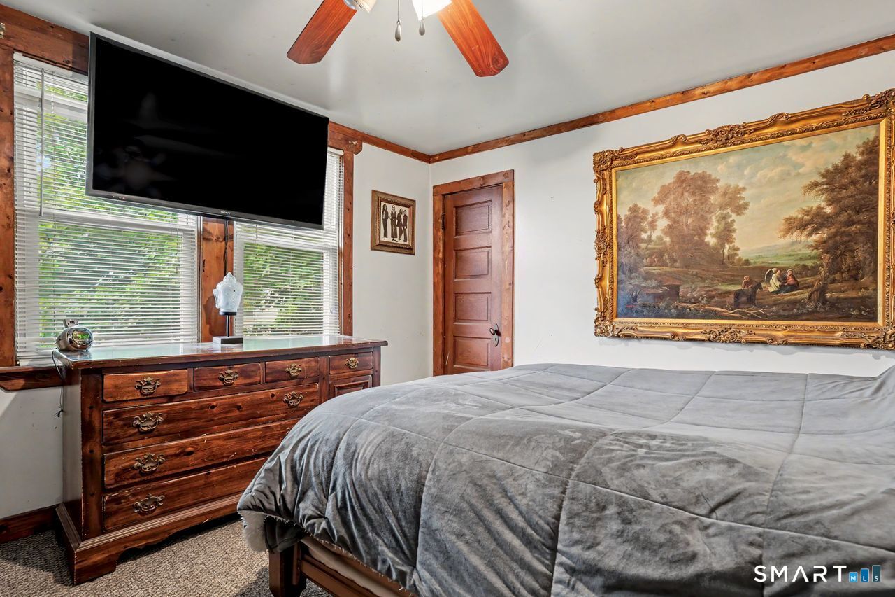 74 Maple Street Seymour, CT 06483 - Photo 24 of 40 a bed sitting in a bedroom next to a window