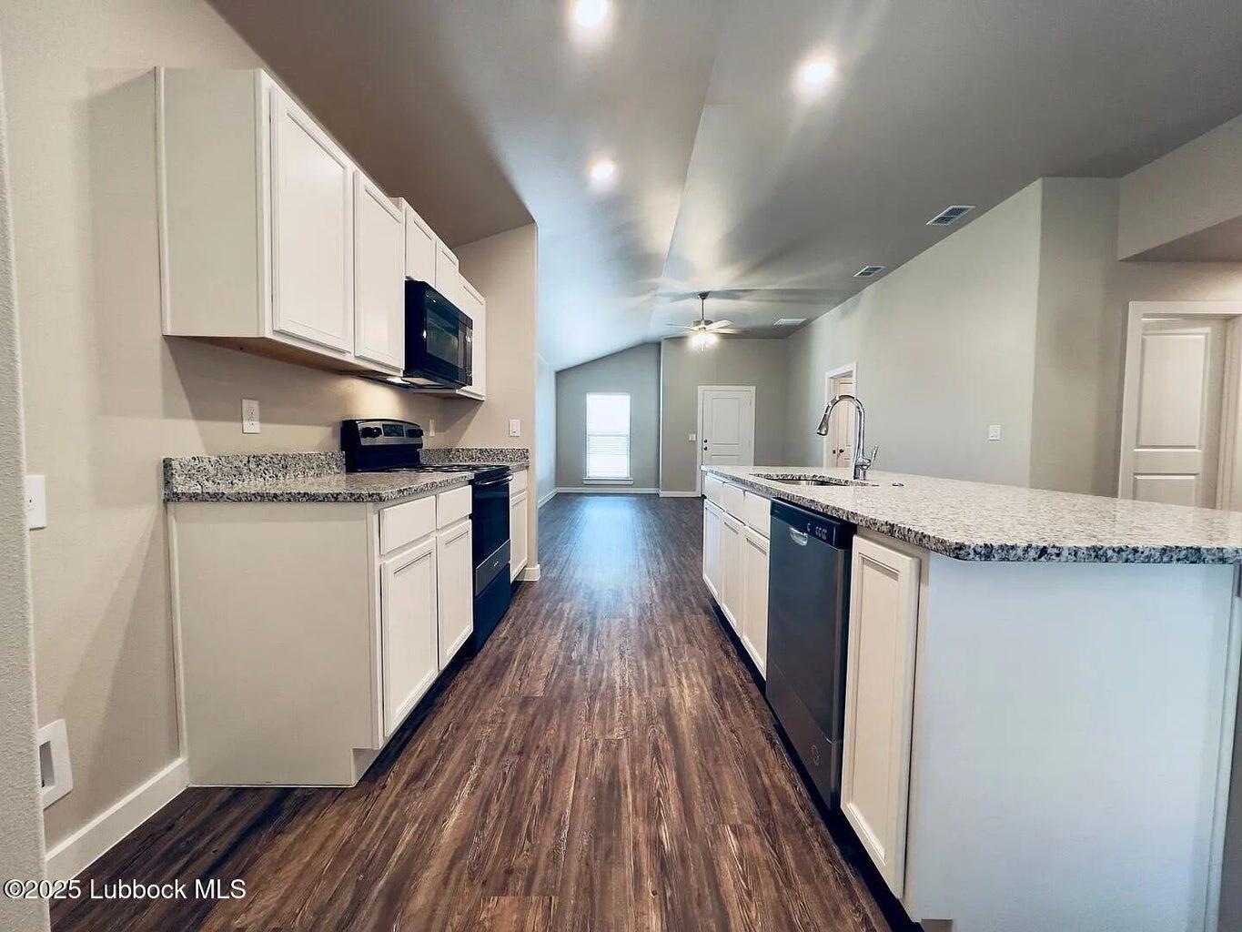 2061 Kenwood Avenue Lubbock, TX 79407 - Photo 2 of 6 a large kitchen with stainless steel appliances granite countertop a lot of counter space and wooden floor