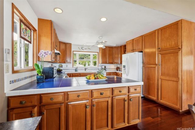 a kitchen with stainless steel appliances granite countertop a sink a stove and refrigerator