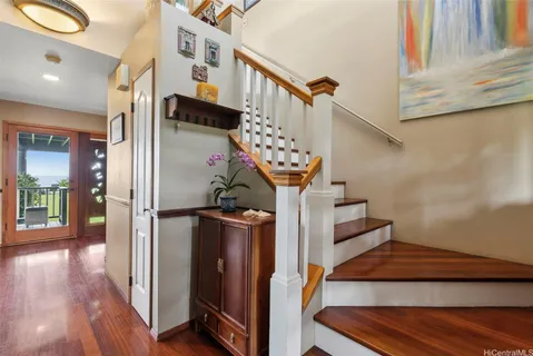 a view of entryway and hall with wooden floor