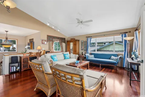 a living room with furniture a wooden floor and a window