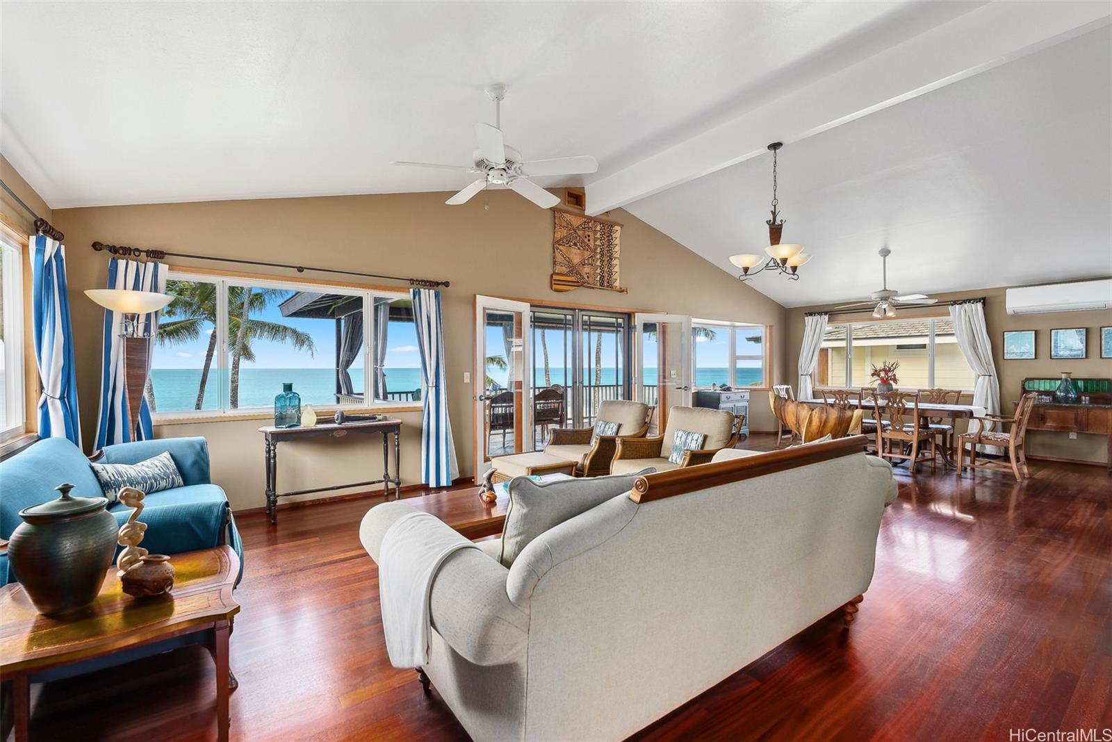 59-535 Ke Iki Road, Unit A Haleiwa, HI 96712 - Photo 7 of 25 a living room with furniture a large window and wooden floor