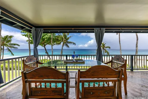 a living room with furniture and floor to ceiling windows