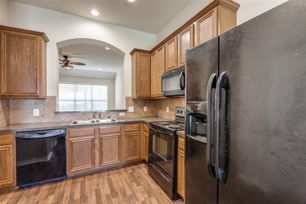 2836 Fordham Road Plano, TX 75025 - Photo 3 of 18 a kitchen with stainless steel appliances granite countertop a sink stove and refrigerator