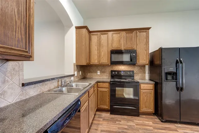 a kitchen with a sink stove and refrigerator