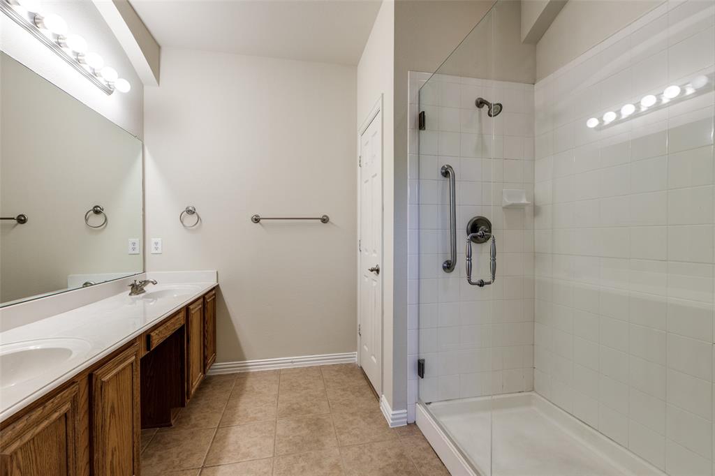 2836 Fordham Road Plano, TX 75025 - Photo 10 of 18 a bathroom with a granite countertop sink a shower and a mirror