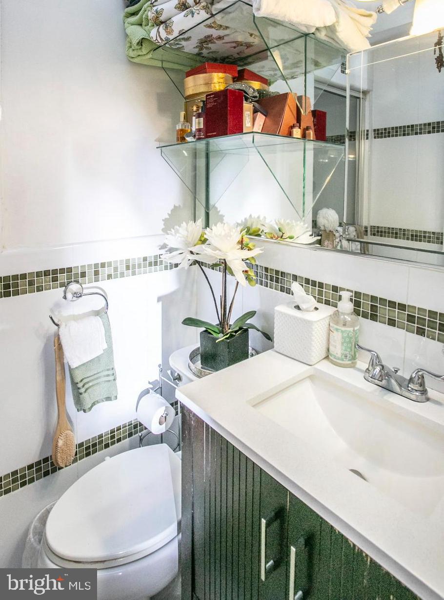 1144 Slocum Street Philadelphia, PA 19150 - Photo 17 of 27 a bathroom with a sink a mirror and a shower