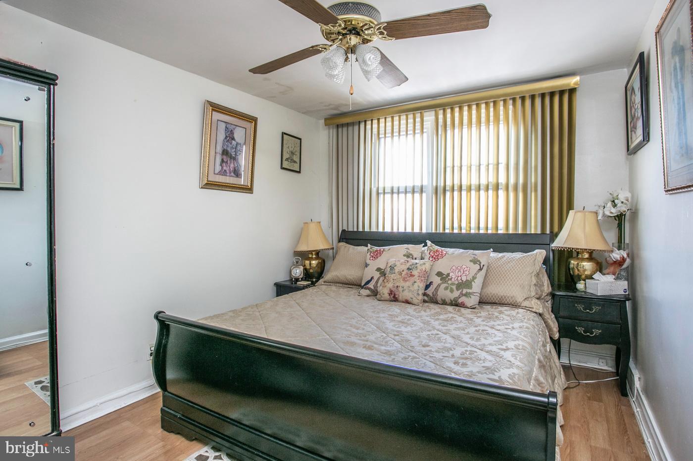 1144 Slocum Street Philadelphia, PA 19150 - Photo 19 of 27 a bedroom with a bed and a chandelier