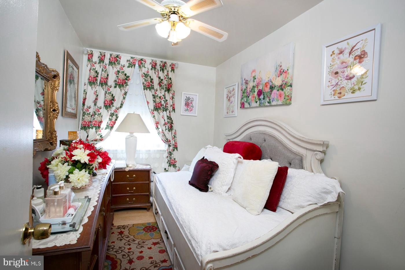 1144 Slocum Street Philadelphia, PA 19150 - Photo 21 of 27 a bedroom with a bed and a chandelier
